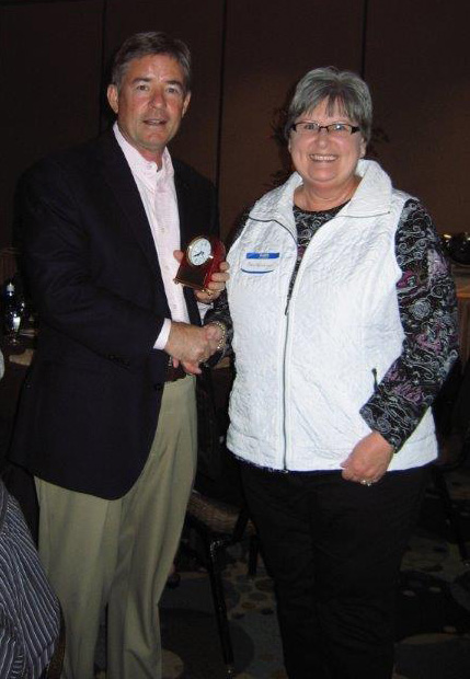 Bev receiving an award from Greg.